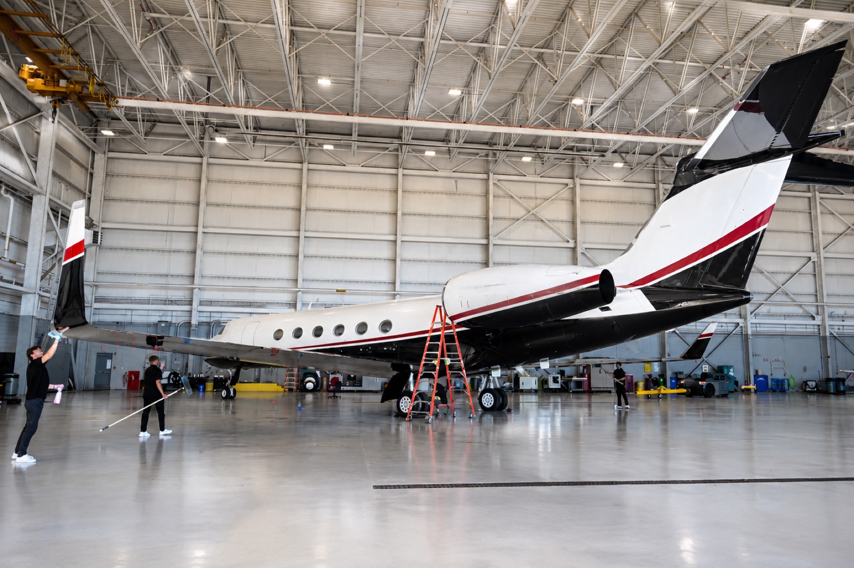A+J Finish crew hand-washing a private jet exterior
