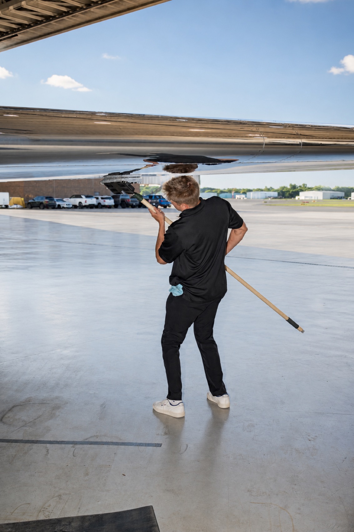 Hand-washing an aircraft wing during exterior detailing